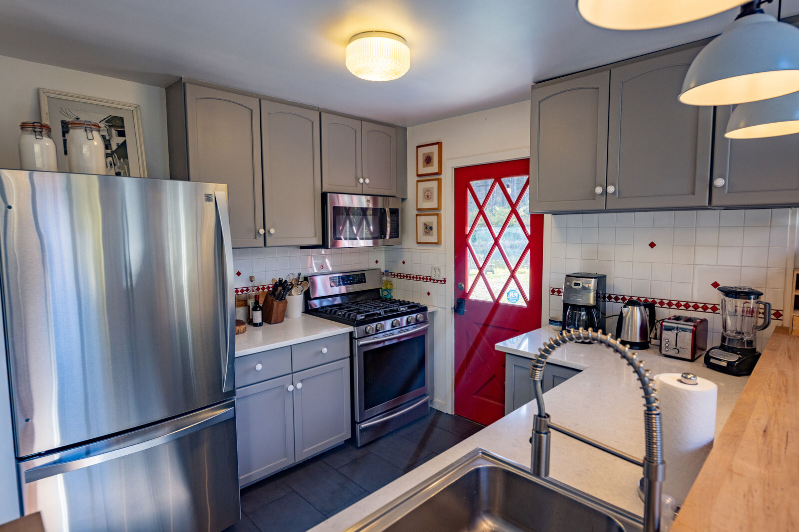 Full kitchen with gas range and the red dutch door